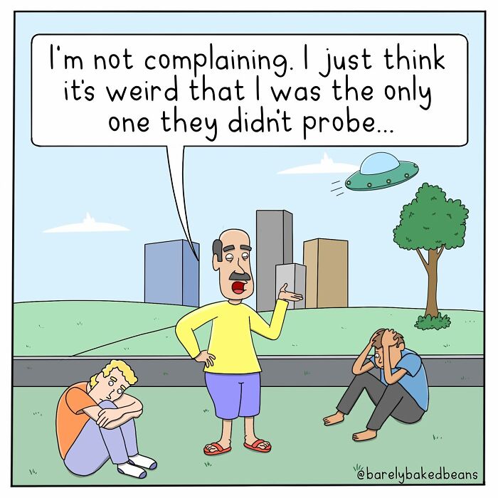 A man in a yellow shirt stands talking to two others sitting on the ground. A UFO hovers overhead. The man comments that he was the only one not probed by the aliens.